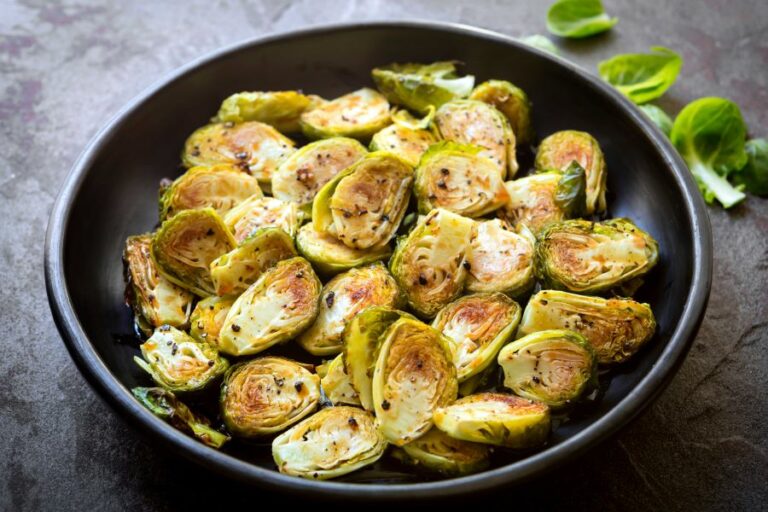 a cast iron frying pan with halved roasted brussels sprouts