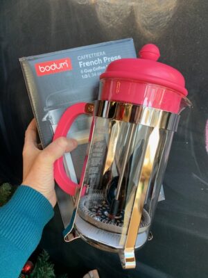 Bodum 8 Cup Caffettiera French Press in Bubblegum Pink being held by a hand, box in the background