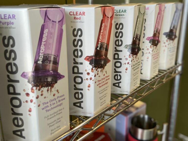 Boxes of Aeropress coffee brewers showing the different colours available.