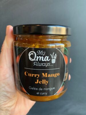 Curry Mango Jelly made by My Oma Always, being held by a hand