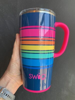 Swig Electric Slide Travel Mug being held by a hand