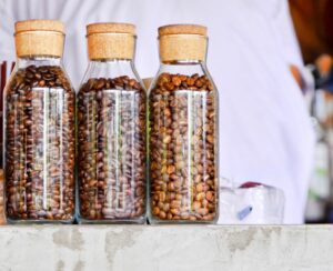 Three corked jars with coffee beans inside them