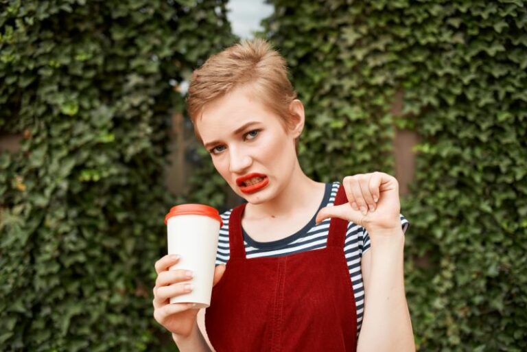 Woman with coffee drink and thumbs down for bad coffee storage.