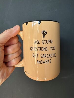 Prairie Chick Mug in light orange with "Ask stupid questions, you get sarcastic answers."