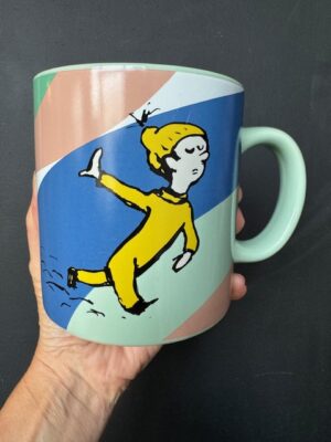 Back of Dr. Seuss "I'll head straight out of town." mug held by a hand