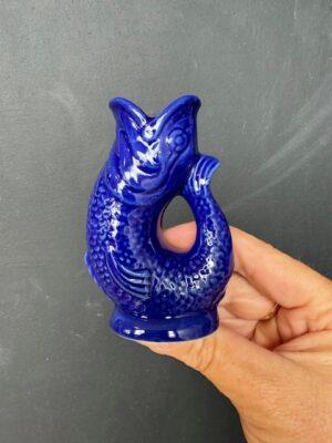 Mini Gluggle Jug in Cobalt Blue being held by a hand