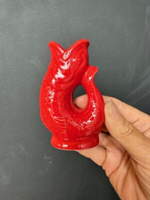 Mini Gluggle Jug in Red being held by a hand