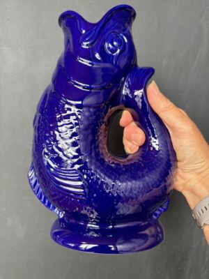 Extra large Gluggle Jug in Cobalt Blue being held by a hand