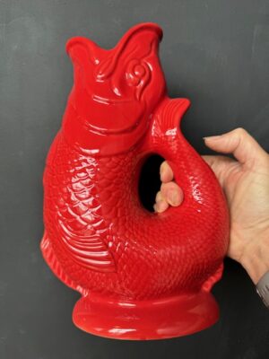 Extra large Gluggle Jug in Red being held by a hand