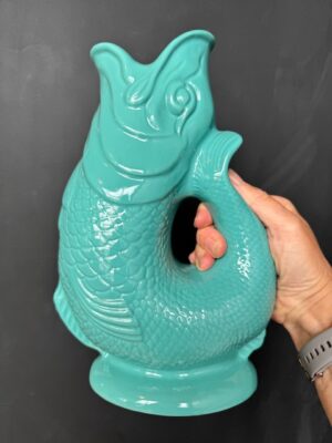 Extra large Gluggle Jug in Sea Green being held by a hand