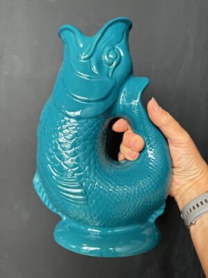 Extra large Gluggle Jug in Teal being held by a hand