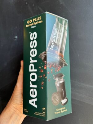 Aeropress Go Plus Black Travel System being held by a hand