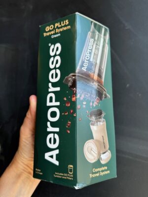 Aeropress Go Plus Cream Travel System being held by a hand