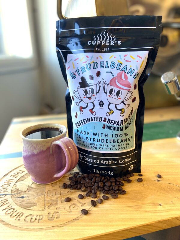 Strudelbrand Strudelbeans medium roast coffee in a bag with a pink cup and coffee beans