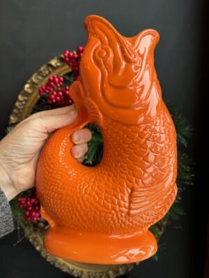 Gluggle Jug XL in Orange being held by a hand