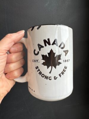 Prairie Chick Mug in white with a maple leaf and text "Canada Strong & Free"