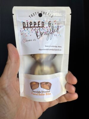 A package containing two Dipped & Drizzled's Chocolate Drizzled Peanut Butter Bites