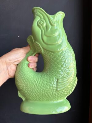 Apple green XL Gluggle Jug in front of a black wall