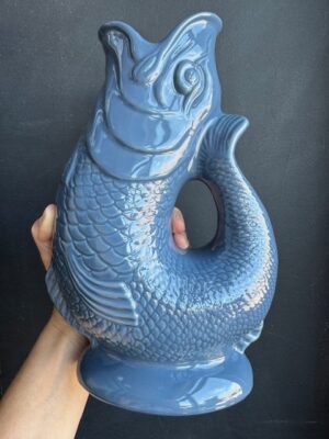 Denim blue XL Gluggle Jug in front of a black wall