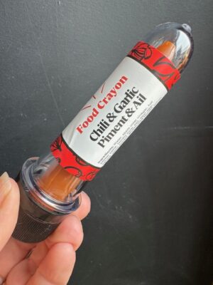 Chili & Garlic food crayon in front of a black background