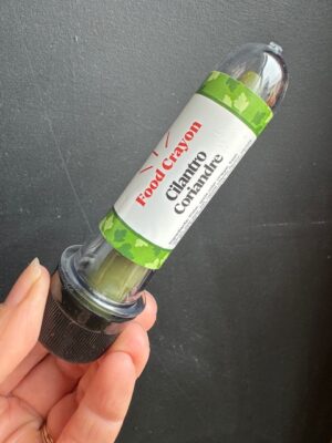 Cilantro food crayon in front of a black background