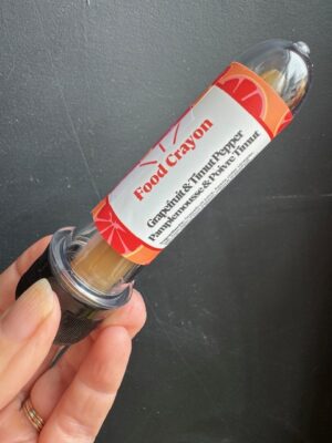 Grapefruit & Timut Pepper Food crayon in front of a black background