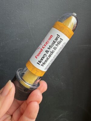 Honey & Mustard Food crayon in front of a black background