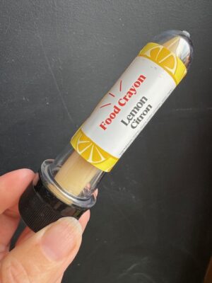 Lemon Food crayon in front of a black background