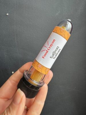 Saffron Food crayon in front of a black background