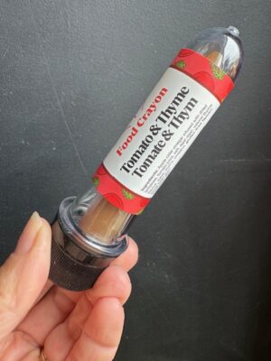 Tomato & Thyme Food crayon in front of a black background