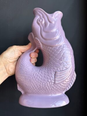 Lilac XL Gluggle Jug in front of a black wall