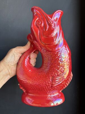 Red Lustre XL Gluggle Jug in front of a black wall