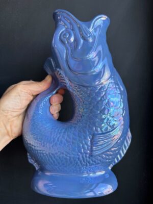 Sea Blue Lustre XL Gluggle Jug in front of a black wall
