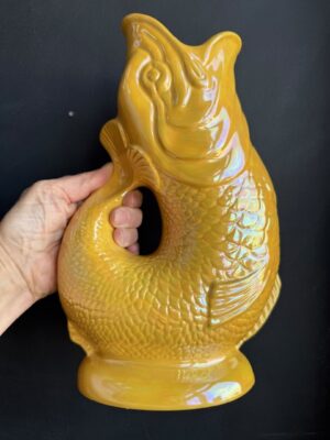 Yellow XL Gluggle Jug in front of a black wall