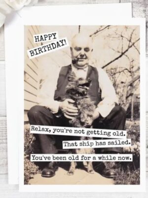 Raven's Rest Studio Greeting Card - "Happy birthday! Relax, you're not getting old. That ship has sailed. You've been old for a while now." Older man with a pipe, sitting on step and holding a small dog.