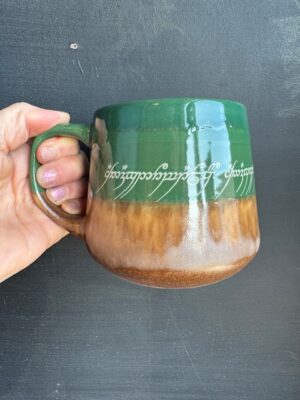 The Lord of the Rings green and brown mug with elven text on it.