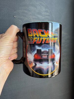 black back to the future mug with the DeLorean driving away in lightning