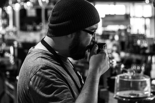 coffee flavor Staff member in a toque sipping coffee