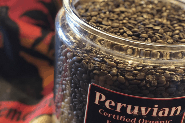 freshly roasted coffee beans Side photo of Peruvian Femenino coffee jar at Cupper's